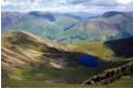 Buttermere village (almost) seen beyond the deep blue of Bleaberry Tarn