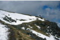 A lone walker approaches the summit of Ingleborough