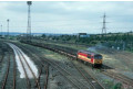 56 051 heads out of the yard with a long train of flat wagons, Healey Mills