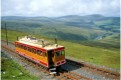 Car no 2 climbs Snaefell; Sulby Reservoir in the background