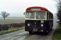 Green Bus Co 521 CTF passes, between trains